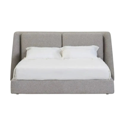 A modern upholstered bed frame with a tall segmented headboard and matching footboard, shown with white bedding and two pillows against a plain white background.