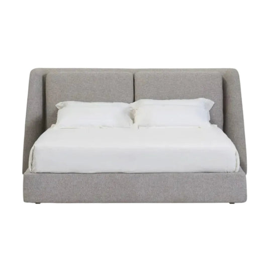 A modern upholstered bed frame with a tall segmented headboard and matching footboard, shown with white bedding and two pillows against a plain white background.