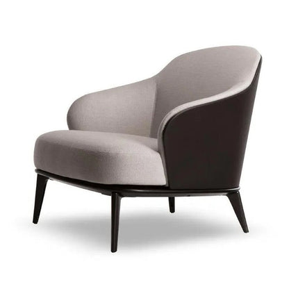 A modern barrel-style accent chair with a curved light gray fabric seat and back, a dark brown side panel, and tapered black legs, shown on a white background.