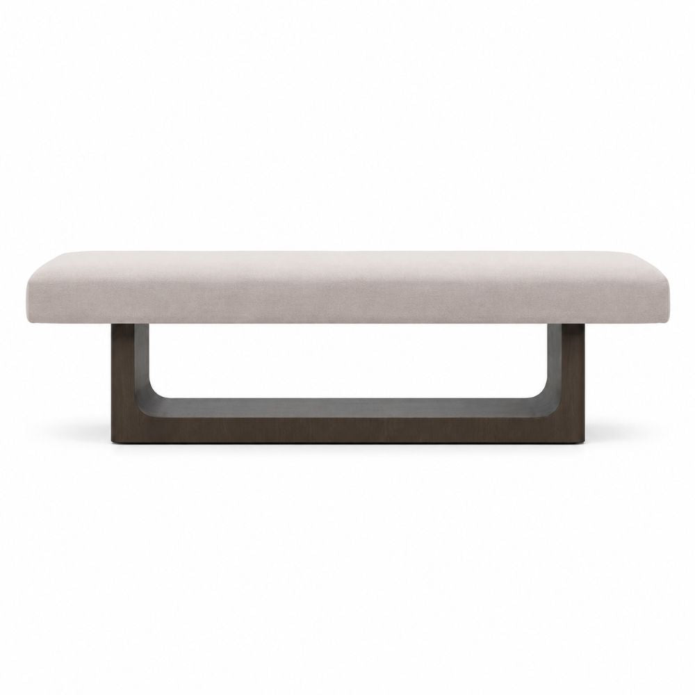 A modern rectangular bench with a light beige upholstered seat and a dark brown U-shaped metal base, shown against a plain white background.