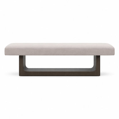 A modern rectangular bench with a light beige upholstered seat and a dark brown U-shaped metal base, shown against a plain white background.