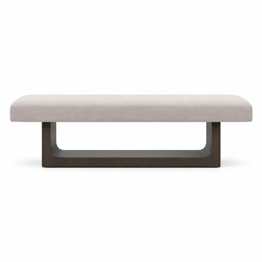 A modern rectangular bench with a light beige upholstered seat and a dark brown U-shaped metal base, shown against a plain white background.