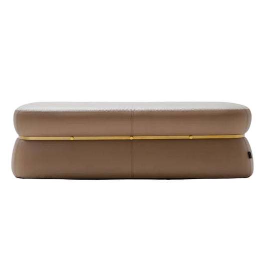 A modern rectangular bench or ottoman upholstered in taupe-brown leather with a thin gold metal accent line across the front, shown against a plain white background.