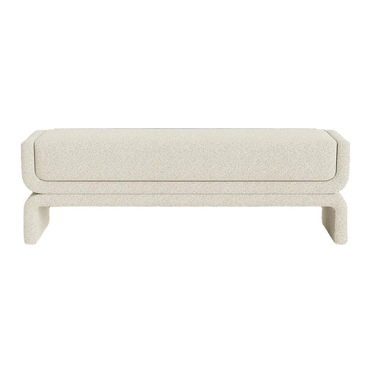 A modern upholstered bench with a textured cream fabric, featuring a thick rectangular seat cushion and sculptural curved legs, shown against a plain white background.
